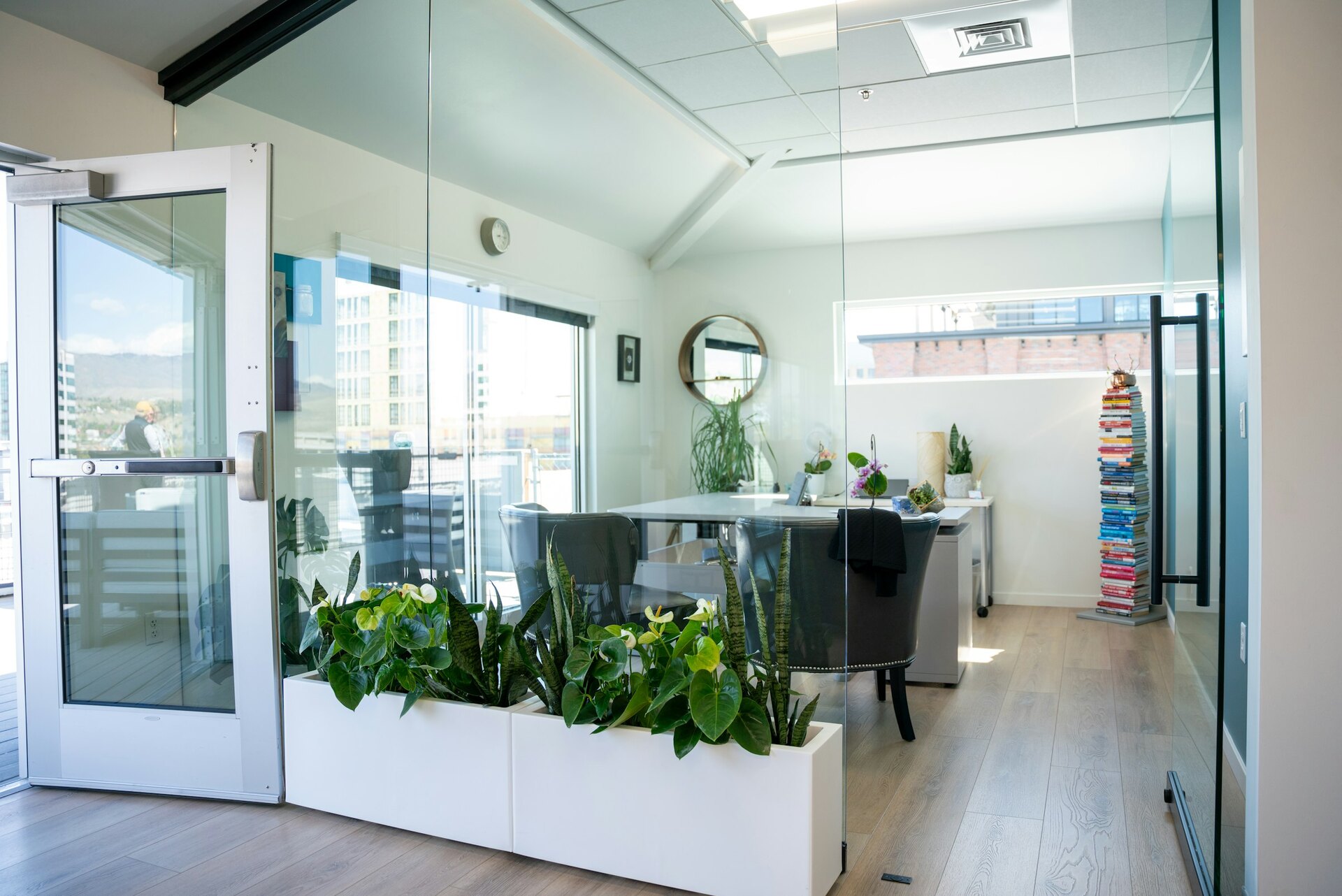 Bright glass-walled commercial office with plants and spotless surfaces