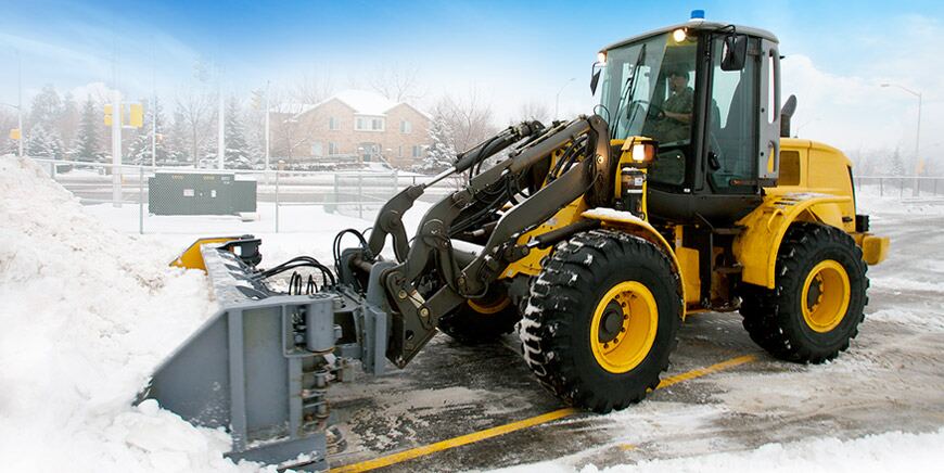 Snow-removal equipment clearing a commercial property