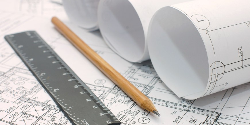 Architectural plans with rulers and pencils