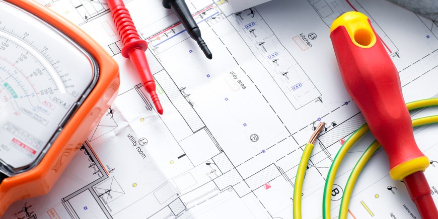 Electrical tools and measuring tape on plans
