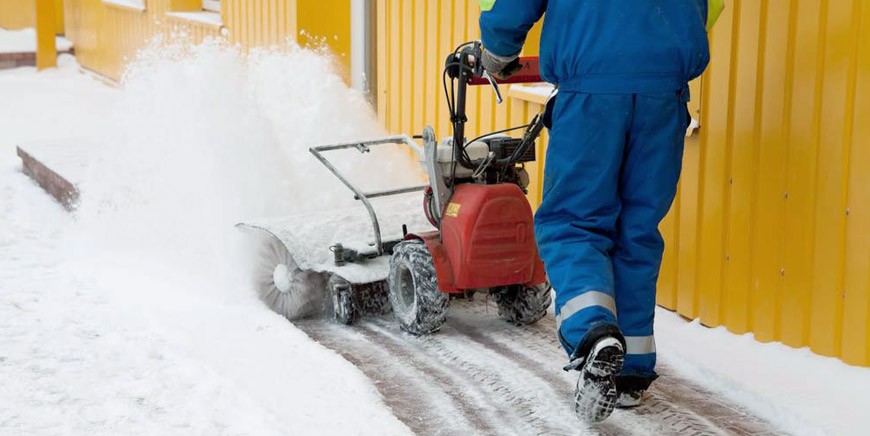 Mechanical snow removal on a pedestrian walkway