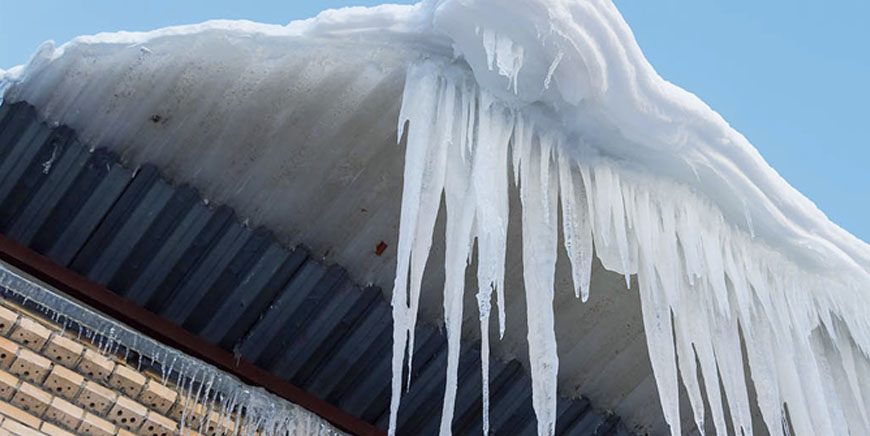 Icicles hanging from the edge of a commercial roof